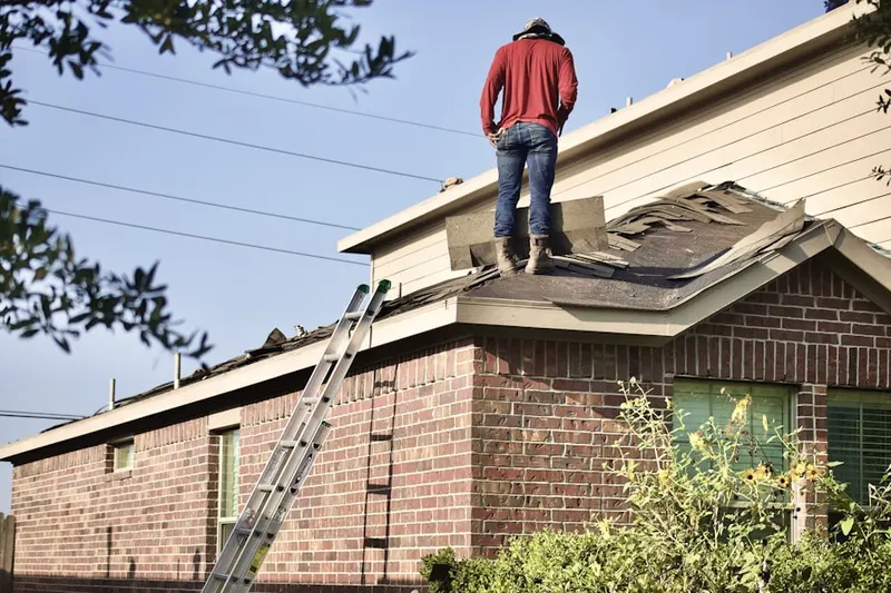 Professional roofer working on a residential roof in Buckeye Ford